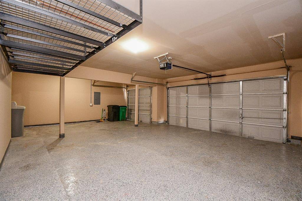 Epoxy Floors and overhead storage to keep your garage clean and tidy