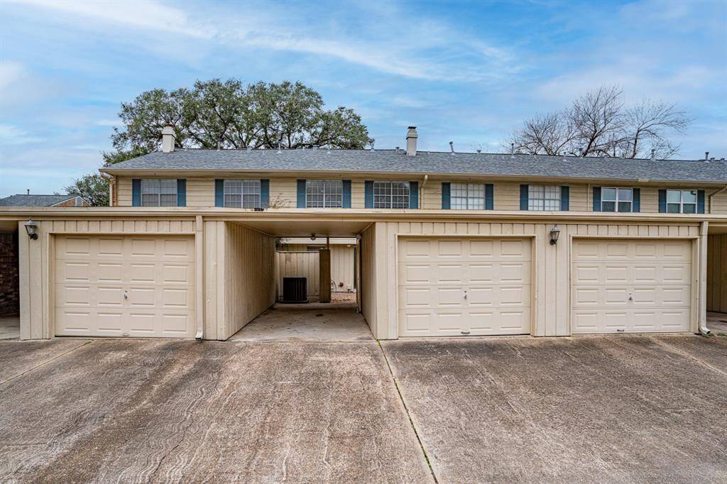 View looking west at carport and garage on left