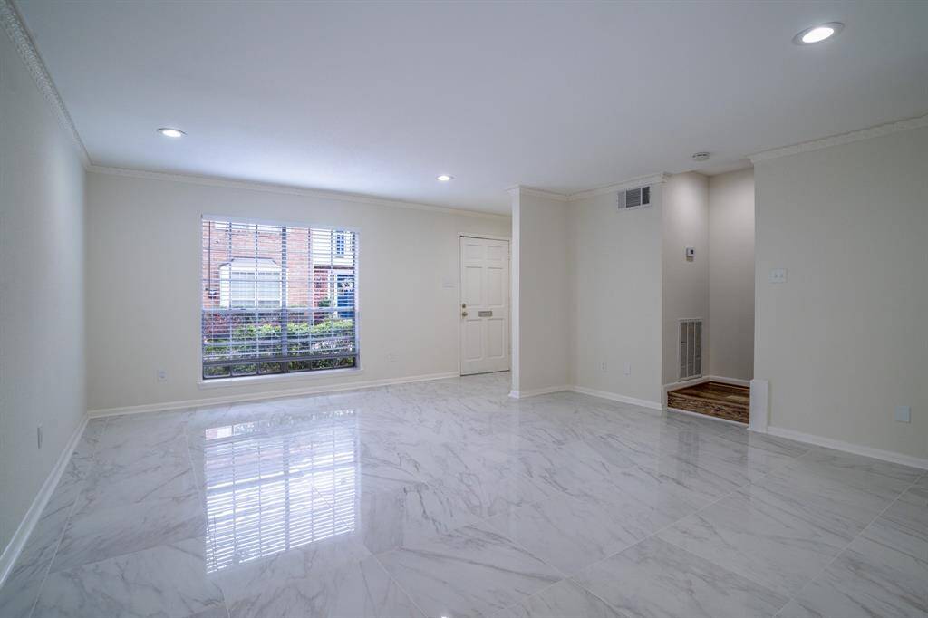 Living room showing stairway to the second floor. Note LED recessed lighting in many rooms.