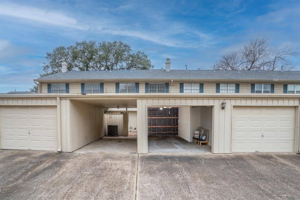 View looking west to carport and open garage.