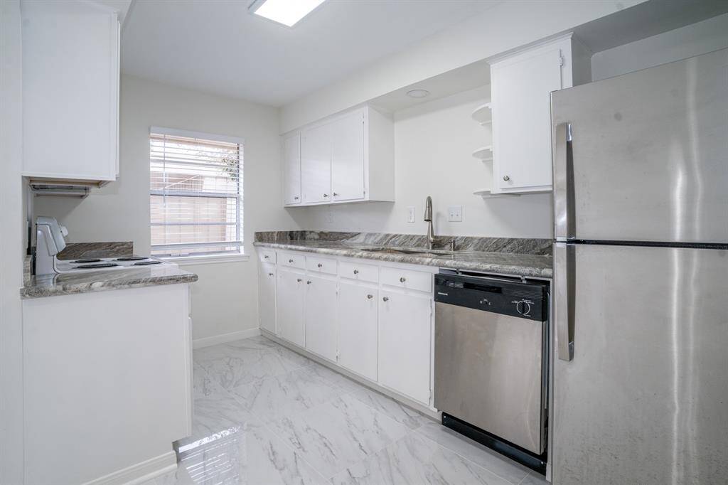 Kitchen with refrigerator, dishwasher, stove and microwave