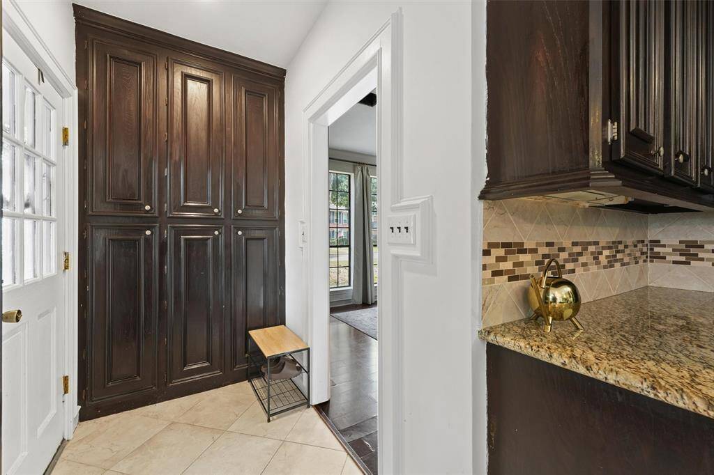 A convenient drop zone with wall-to-wall cabinetry offers excellent storage just off the kitchen and garage.