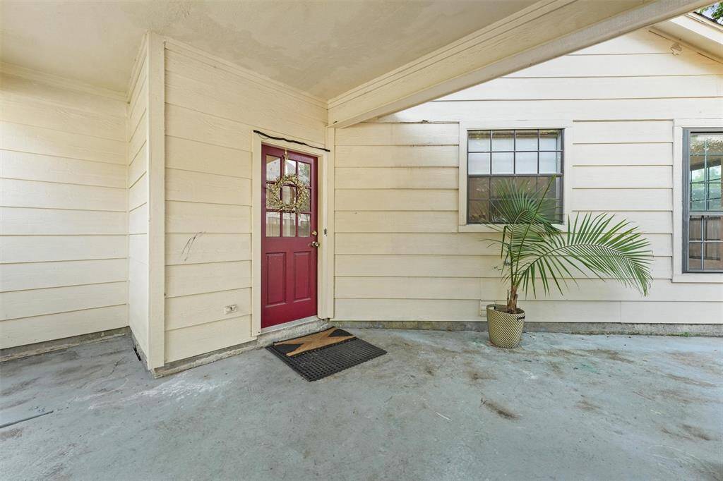Covered breezeway with private entrance adds charm and functionality to this home’s layout