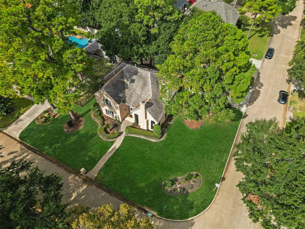 This stunning home sits on an oversized corner lot with lush landscaping and towering trees offering both space and privacy.