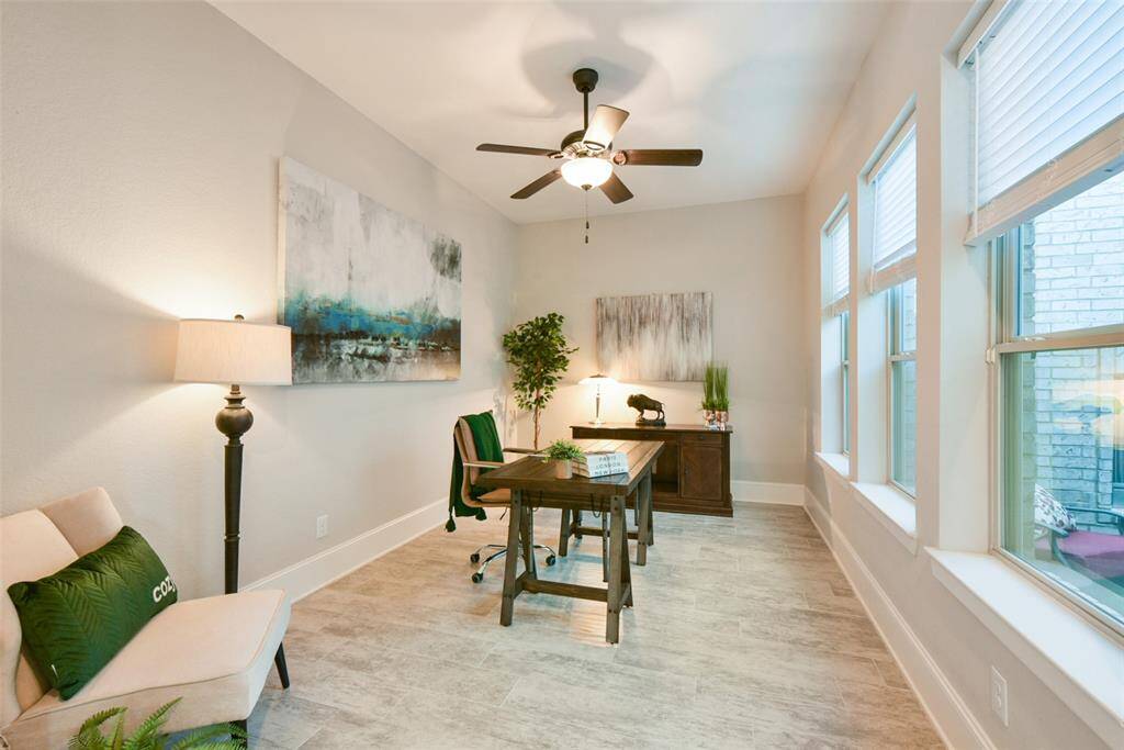 Spacious home office with views to the courtyard and fireplace. All the natural light makes for a wonderful work space.