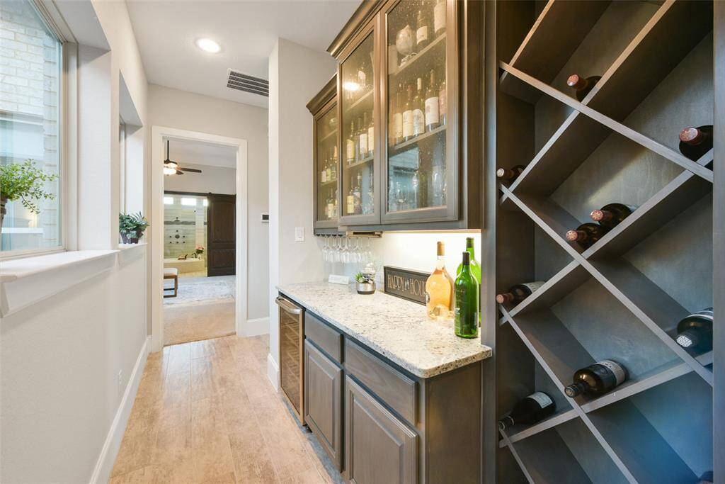 Wine grotto and butlers pantry awaits you off the enclosed patio!