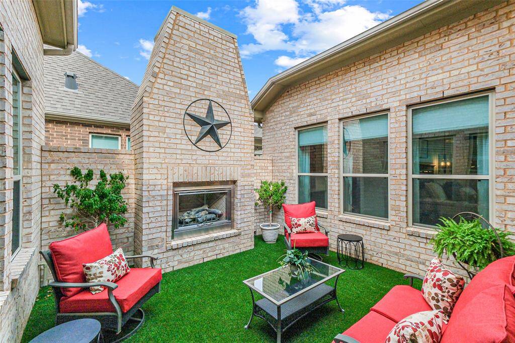 Patio with gas burning fireplace and turf for all season use.