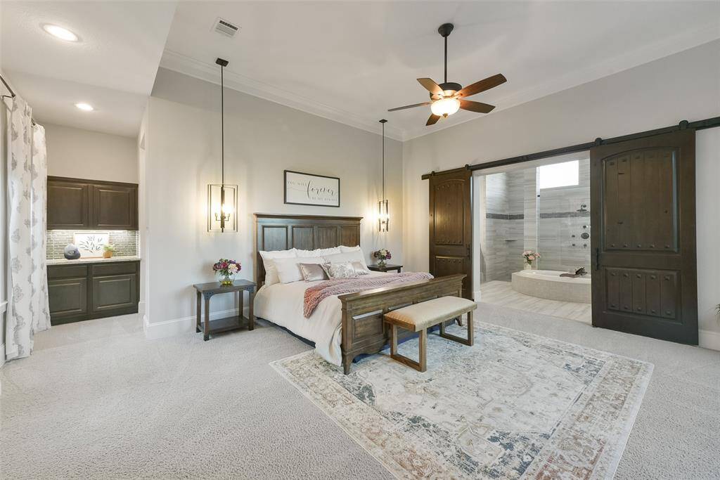 Coffee bar to the left, and spa bath to the right! Gorgeous hanging pendant lights compliment the custom barn doors.