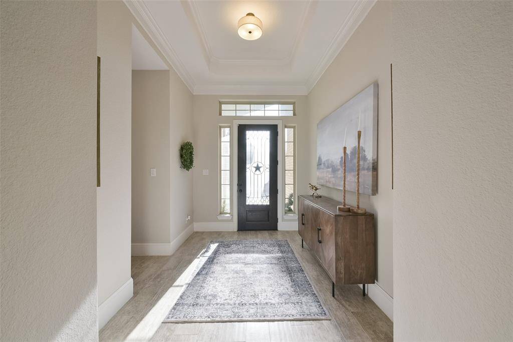 Inviting entryway with tray ceilings.