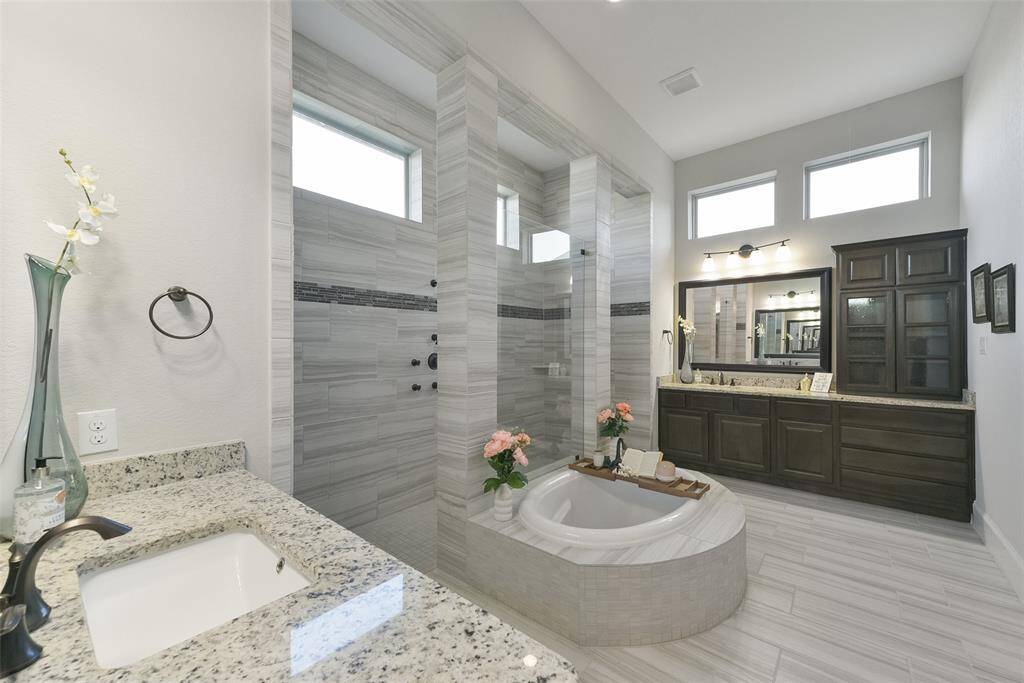 Walk in shower with entry on both sides of the soaking tub!