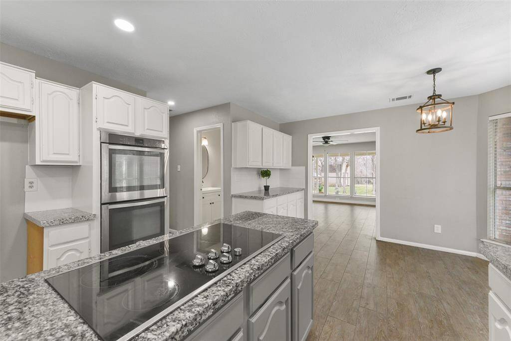 The chef of the house is certain to appreciate the roomy corner pantry, the oversized single-basin sink with panoramic bay windows, and the recent appliances that include a smooth glass downdraft cooktop, dual ovens, & a dishwasher.