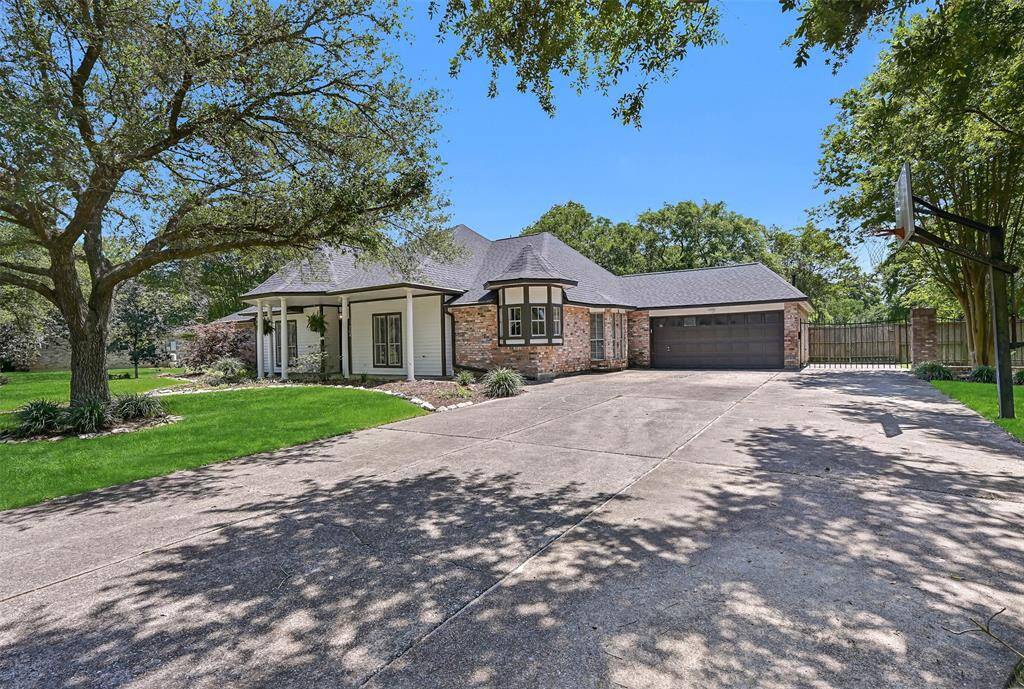 Parking will never be a problem here with this lengthy triple-wide extended driveway complete with an iron gate to another concrete parking pad alongside of the 2-car garage.