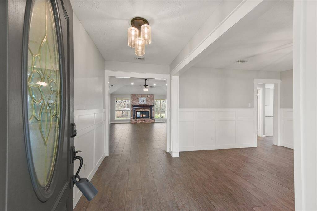 The covered front porch makes way to a charcoal-painted front door that opens to this light and bright open-concept floor plan with abundant natural light streaming in from all directions. Neutral paint and durable wood-look tile floors flow throughout the living space.