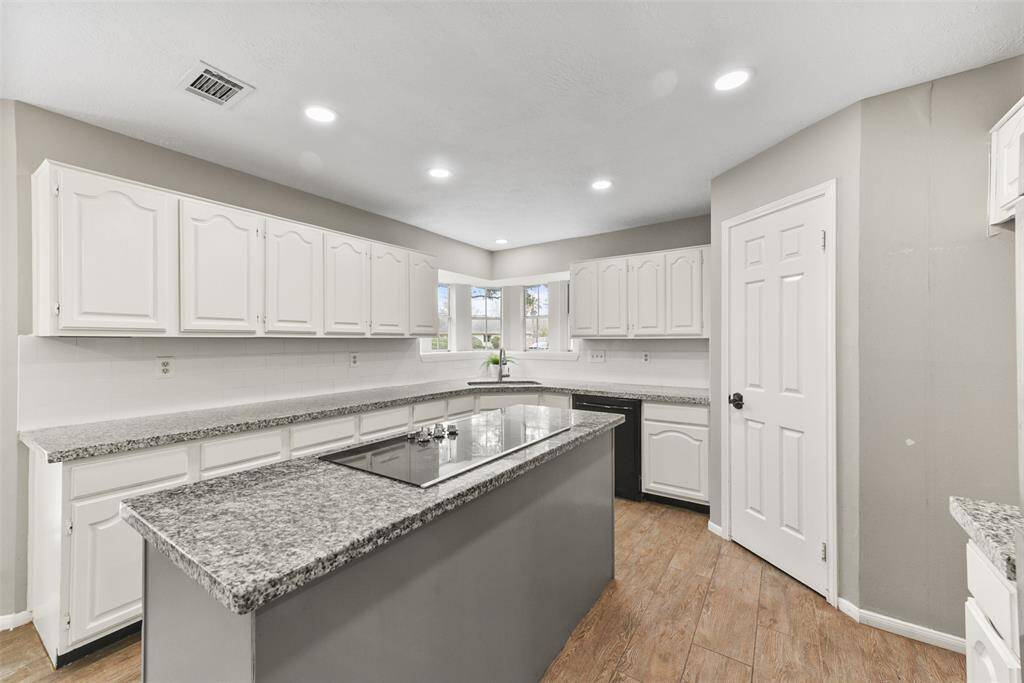 The chef of the house is certain to appreciate the roomy corner pantry, the oversized single-basin sink with panoramic bay windows, and the recent appliances that include a smooth glass downdraft cooktop, dual ovens, & a dishwasher.