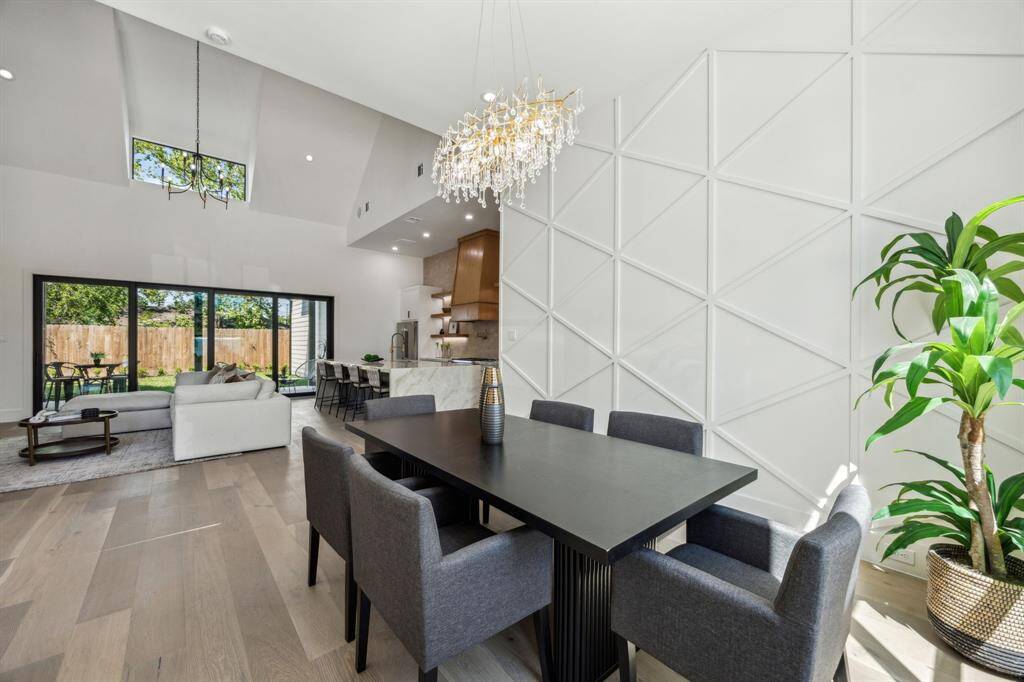 Custom accent wall in the dining room, and look at that dining chandelier!