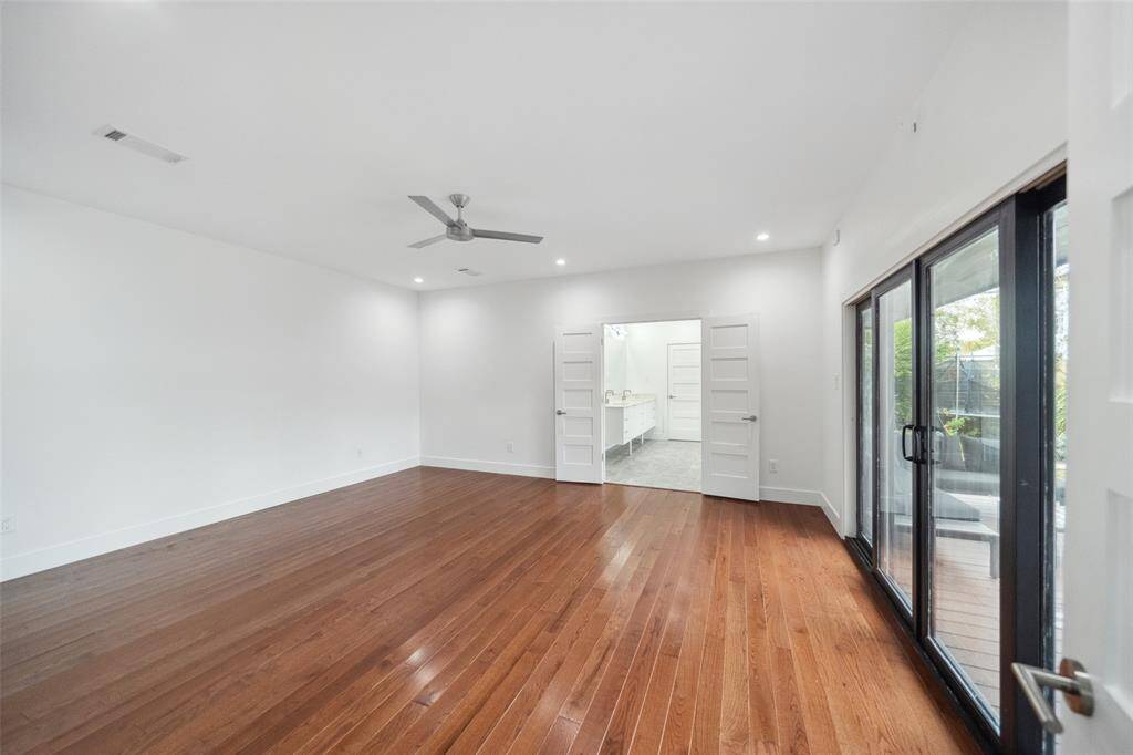 Welcome to the primary retreat! Hardwood floors continue into the space as well as direct access (and views) into the backyard and deck.