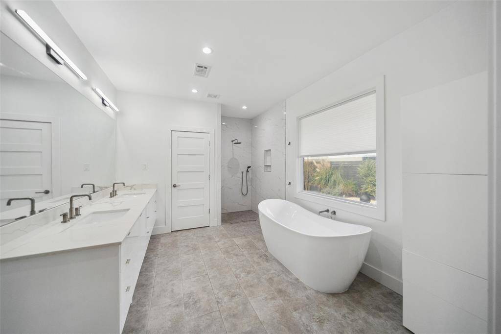 The primary en-suite bath is perfect for relaxing in a spa-like setting. It has all the modern amenities you could want.