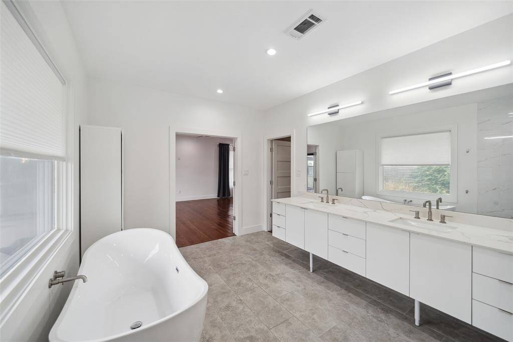 Sit back a relax in the enormous soaking tub. Double vanity and tons of storage adorn this primary bath.