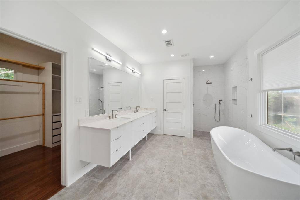 Sleek open-air shower and WC complete the primary bath. Notice just to the left... the closet!