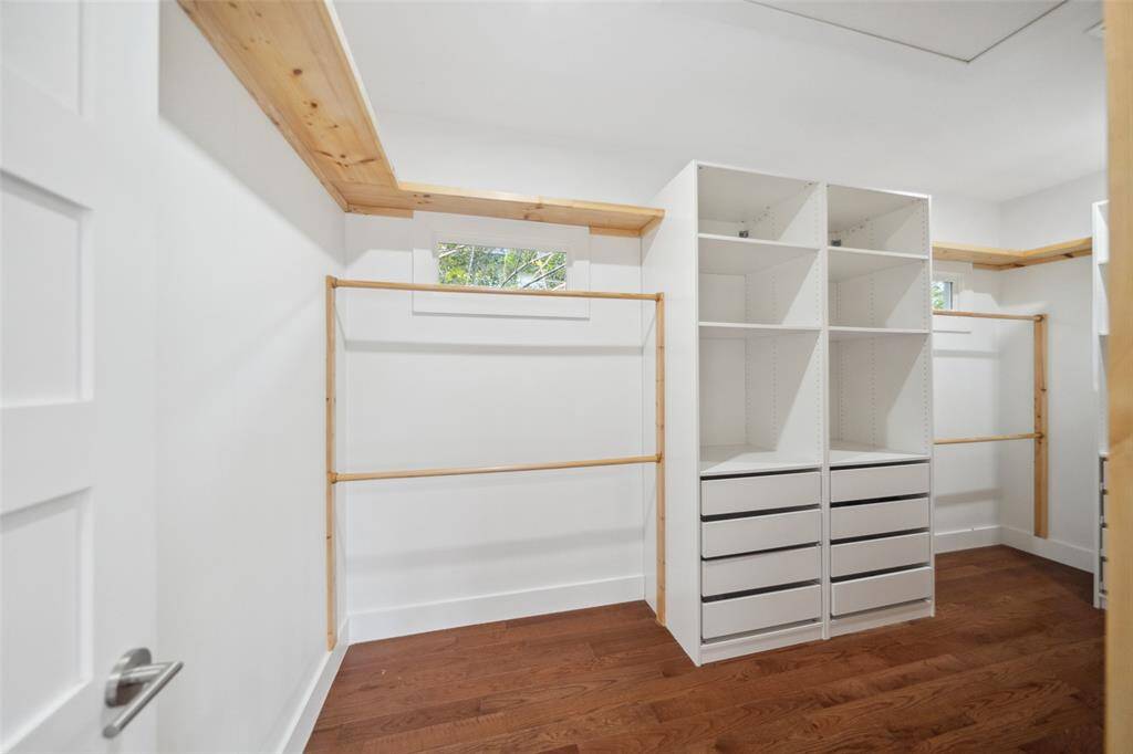 Oversized primary walk-in closet! Complete with shelving, hanging rods, and built-ins.