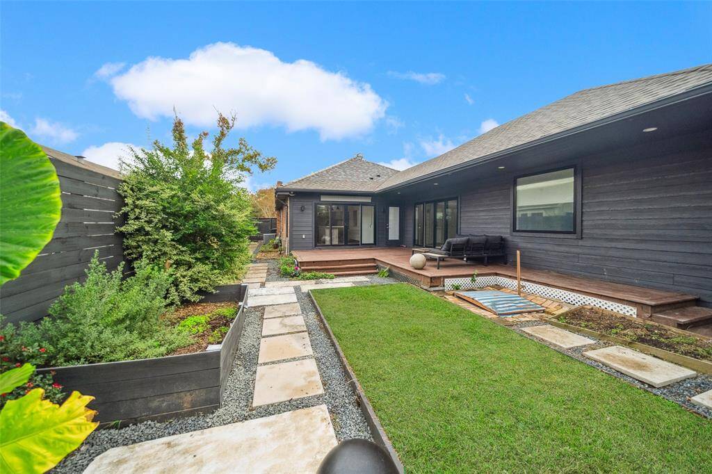 Beautiful stone walkways and charming green spaces complete this backyard.  Not pictured: additional yard space next to the former garage.