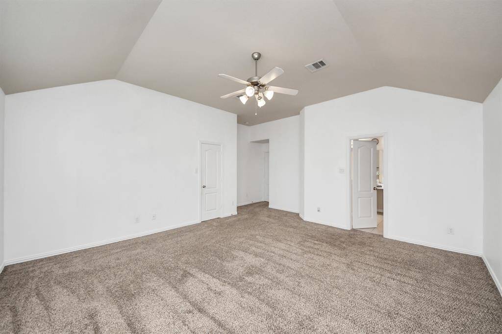 Welcome to the spacious primary bedroom, large enough to comfortably accommodate a California king-size bed.