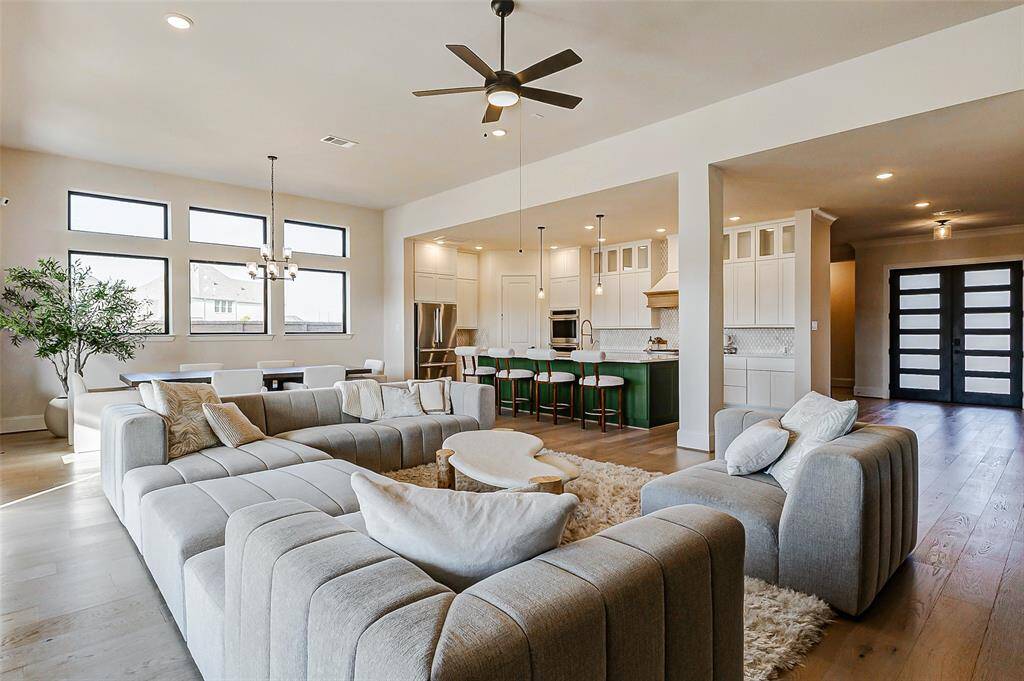 The streamlined kitchen overlooks the bright, open living spaces, offering an abundance of culinary conveniences that make hosting and entertaining effortless.
