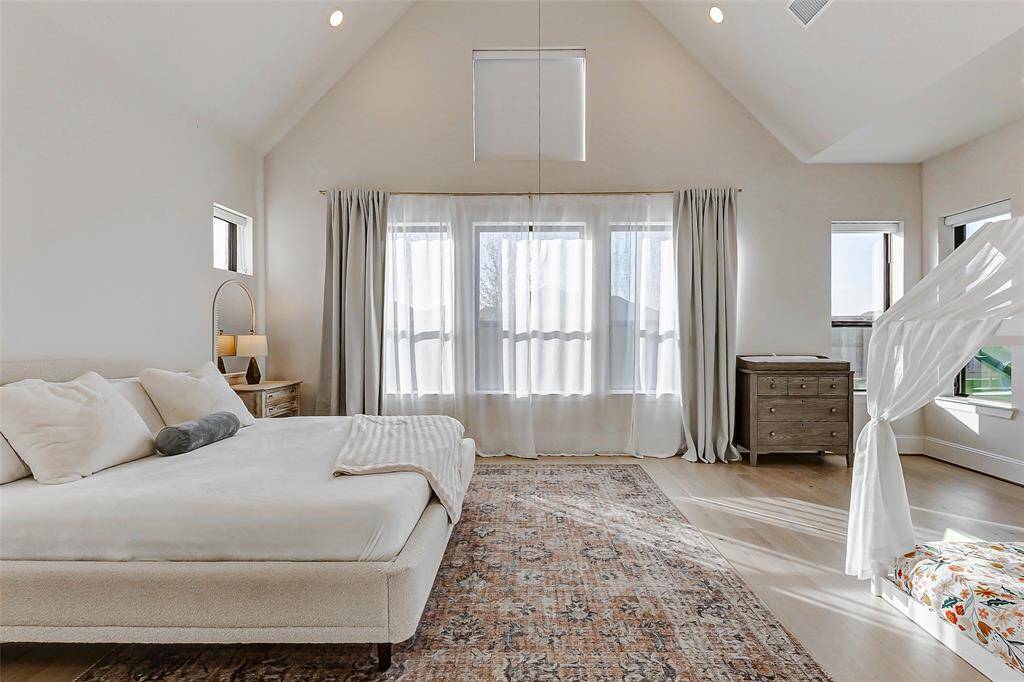 Take note of the abundance of picture windows that frame serene views of the backyard, filling the room with natural light. Additional features include designer paint, thick baseboards, and wide-plank hardwood floors that elevate the space with timeless elegance.