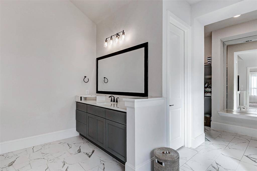 Additional features include stunning marble veining flooring, thick baseboards, and designer paint that elevate the space with elegance. The private commode adds comfort and seclusion, while spacious closets with a built-in dressing mirror and convenient laundry access complete this thoughtfully designed retreat.