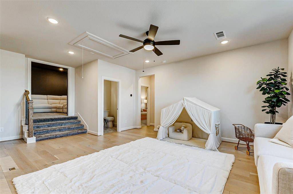 Just off the game room, you’ll find a conveniently located half bathroom. Ascend the carpeted stairs to discover your dedicated media room, ready for immersive entertainment.