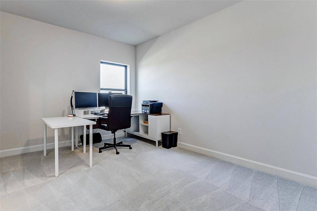 One of two guest bedrooms upstairs, this room features neutral paint, plush carpeting, a spacious closet, and a large window that fills the space with natural light.