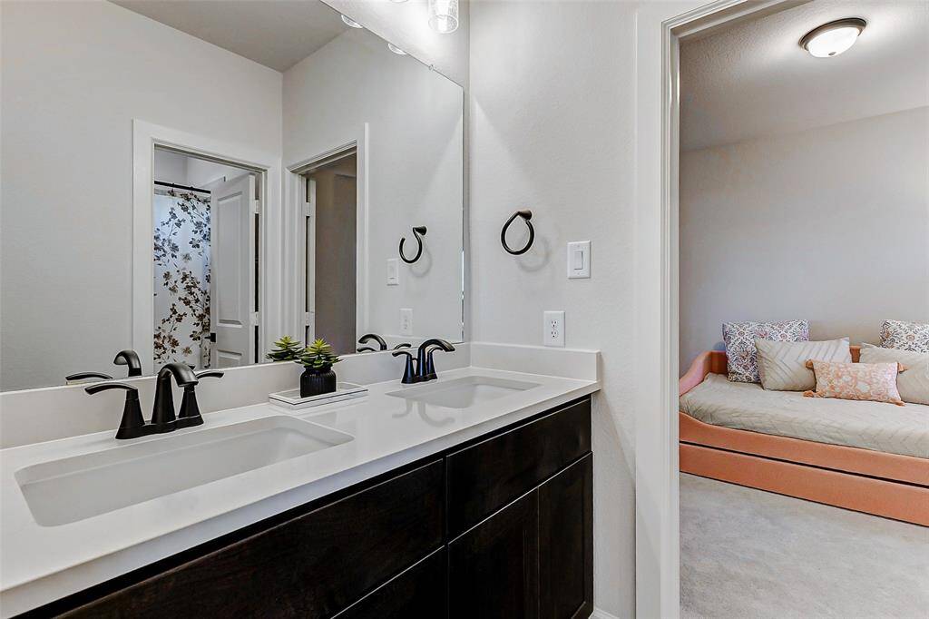 An alternate view of the Hollywood bath reveals the tub/shower combination, thoughtfully tucked away behind a door for added privacy—allowing you to easily get ready while maintaining comfort and seclusion.