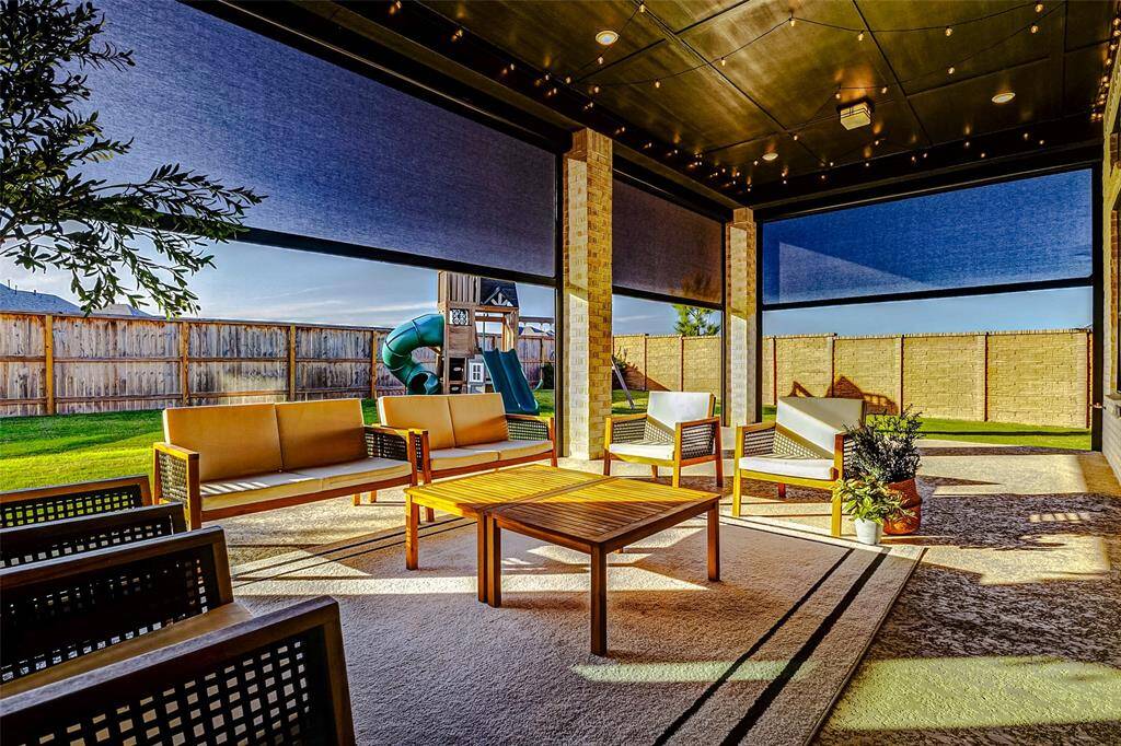 This fabulous patio is equipped with motorized Shade Doctor shades installed on all sides of the extended patio. Remote-controlled for convenience, these durable Kevlar shades are designed to withstand high winds, providing both comfort and protection.