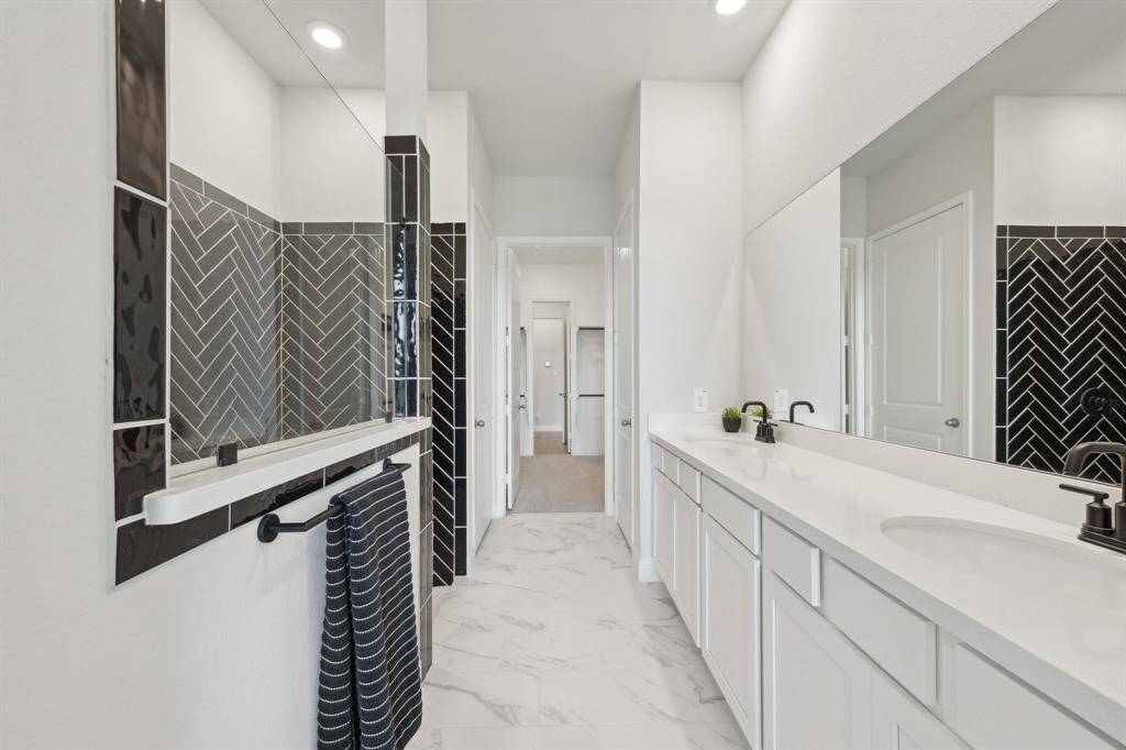 Ensuite bathroom has double sinks and large walk in shower.