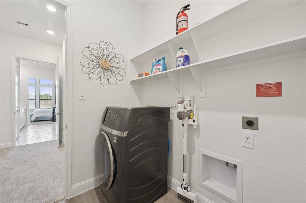 Laundry room has access to primary closet