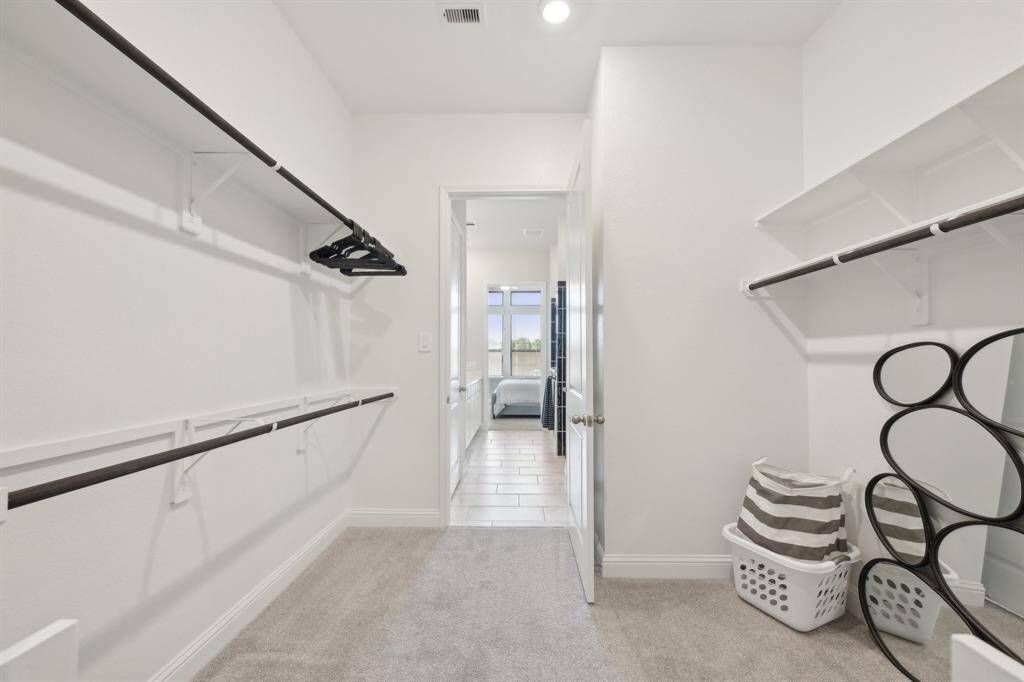 Huge walk in closet in primary bedroom.