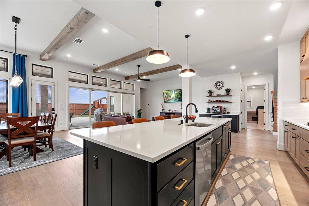 The sprawling island with breakfast bar seating serves as a versatile centerpiece, providing additional workspace, storage, and seating.