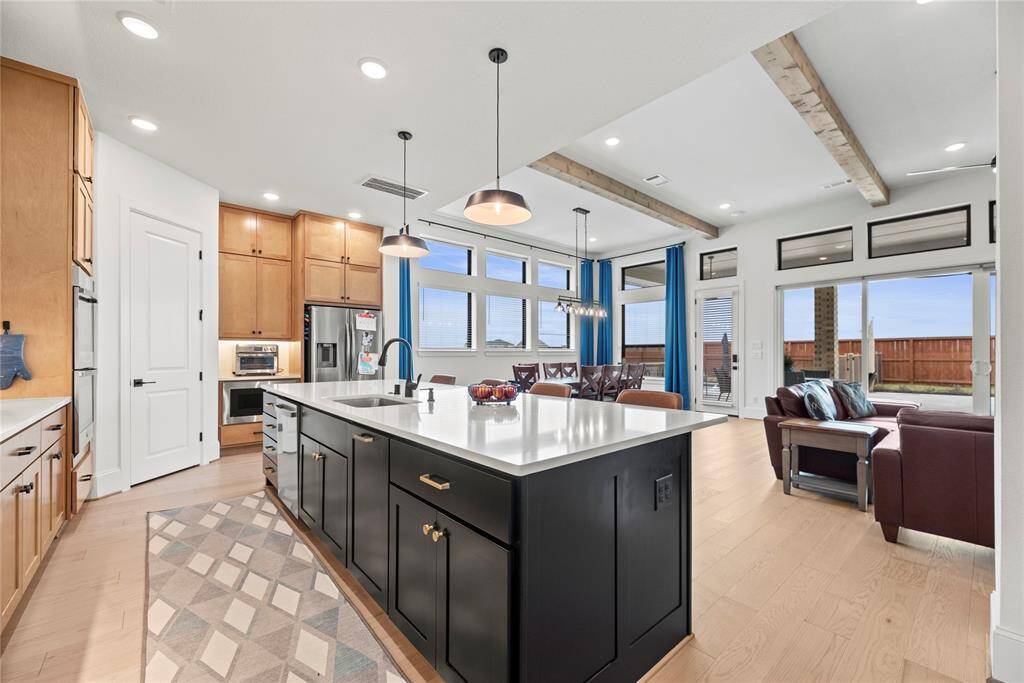 In this open concept design, the kitchen serves as the heart of the home, where meals are prepared, conversations flow, and memories are made.