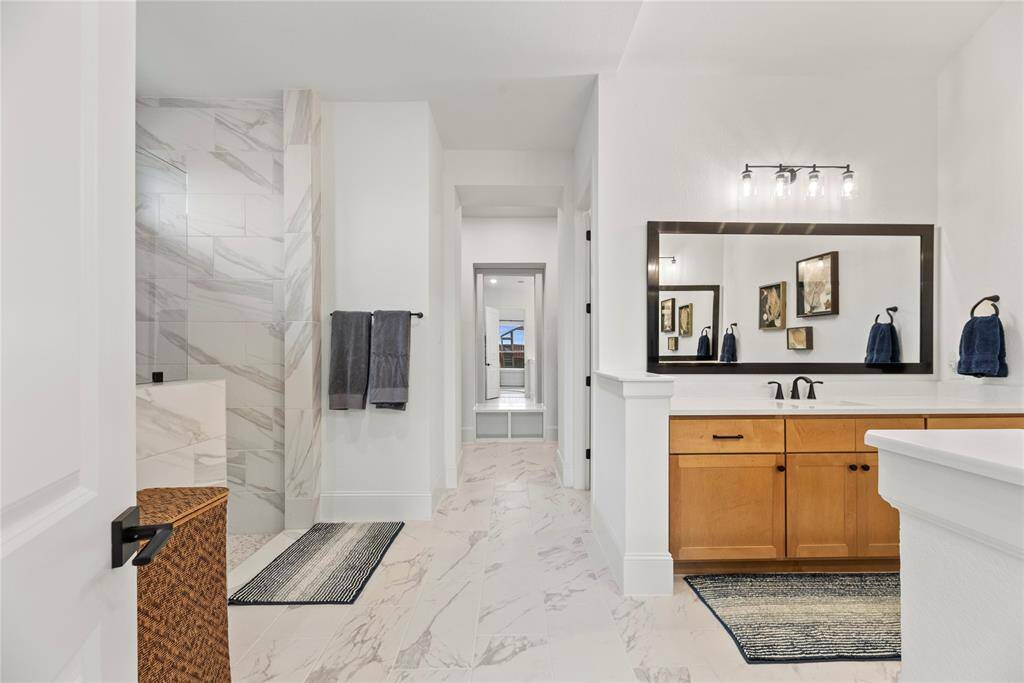 This elegantly designed primary bath combines both functionality and style, transforming your daily routine into a spa-like experience.