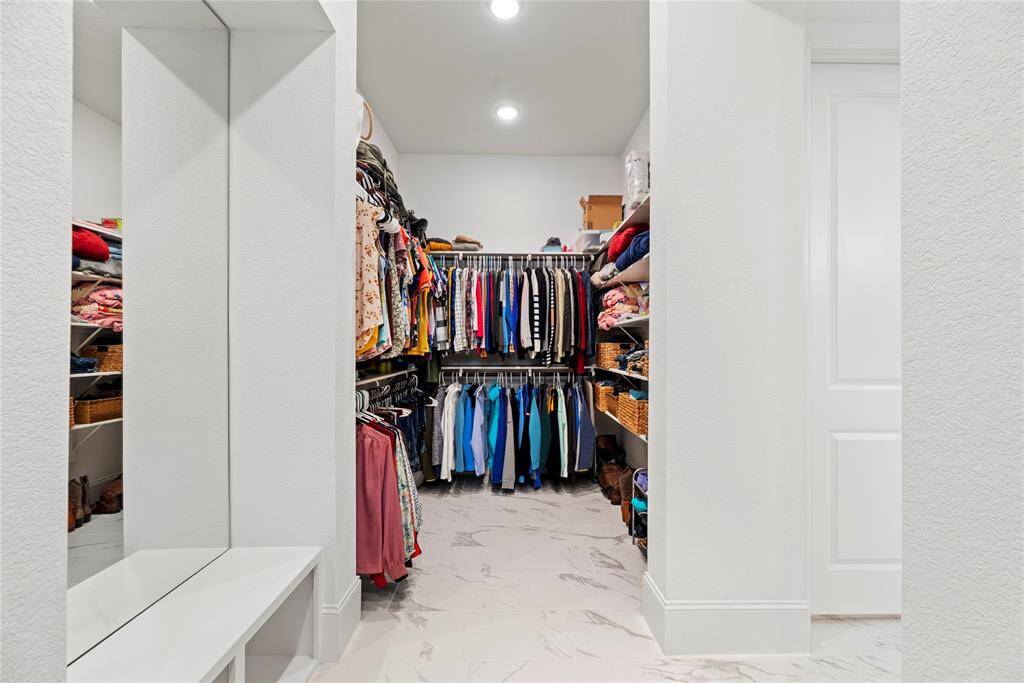 The primary closet provides generous space to store your entire wardrobe while keeping everything neatly organized and easily accessible.