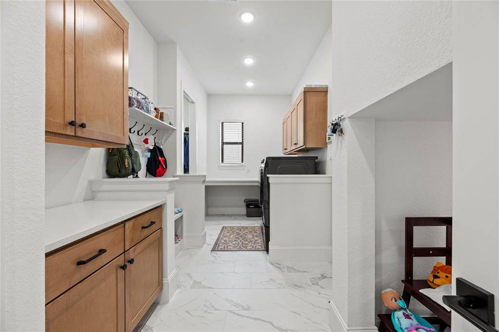 This well-appointed space includes ample storage and efficient organization, making laundry day a breeze while keeping your home tidy and functional.