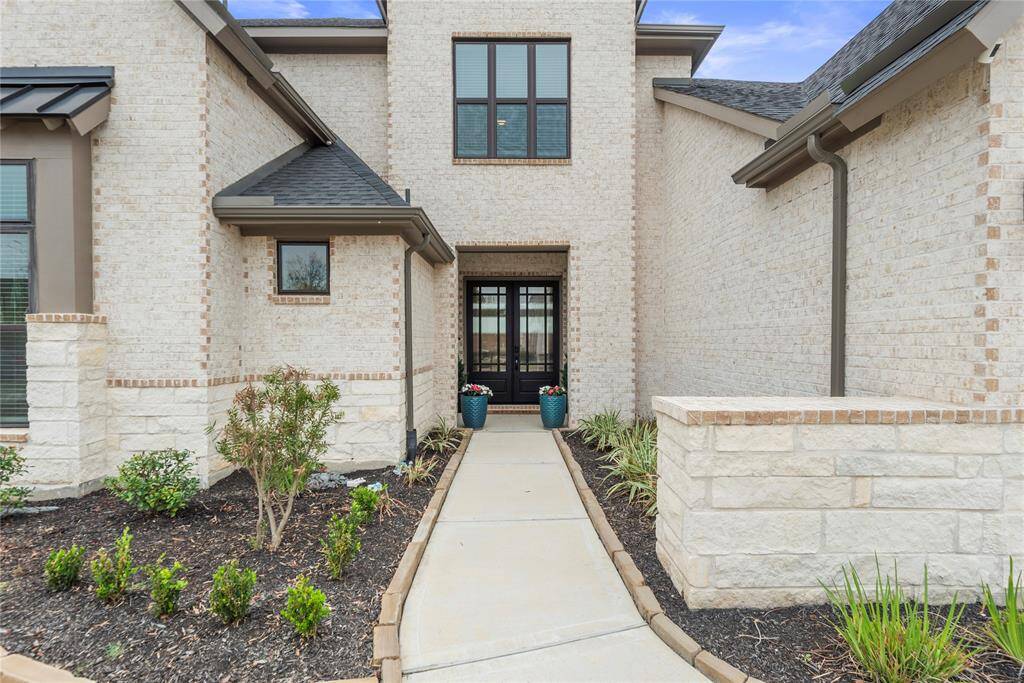 The stunning stone and brick exterior exudes charm and elegance, creating exceptional street appeal that captivates at first glance.