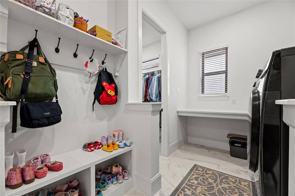 Mud room, smart storage solutions keep clutter at bay. This space simplifies the coming and going of the family and keeping everything organized.