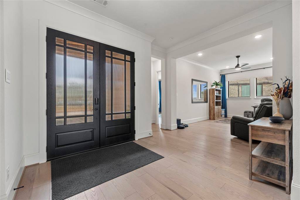 An alternate view of the gorgeous front foyer. Take a moment to admire the stunning engineered wood flooring that adds warmth and elegance to every step.