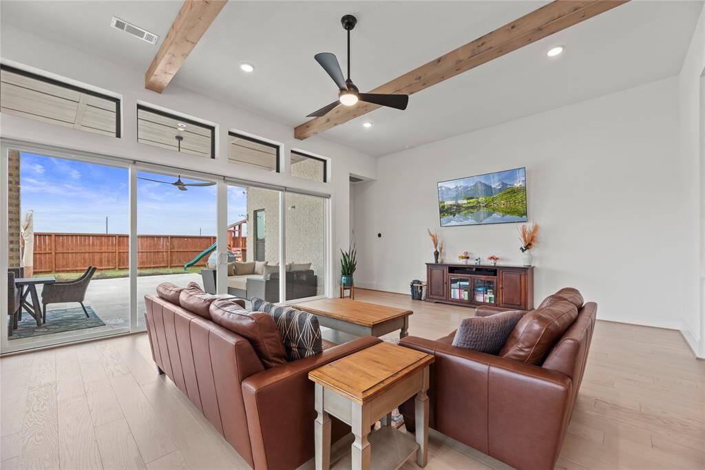 The large glass sliding doors and windows not only bring in abundant sunlight but also offers expansive views of the surrounding landscape, connecting the indoors with the outdoors in a seamless way.