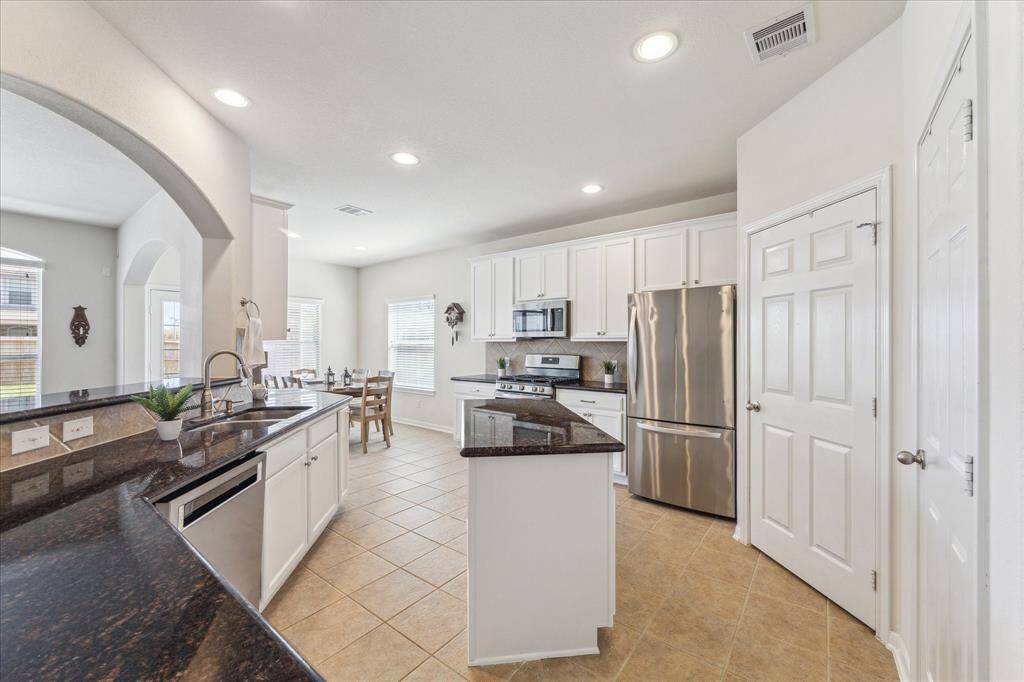Updated island kitchen w/ granite counters and stainless steel appliances.