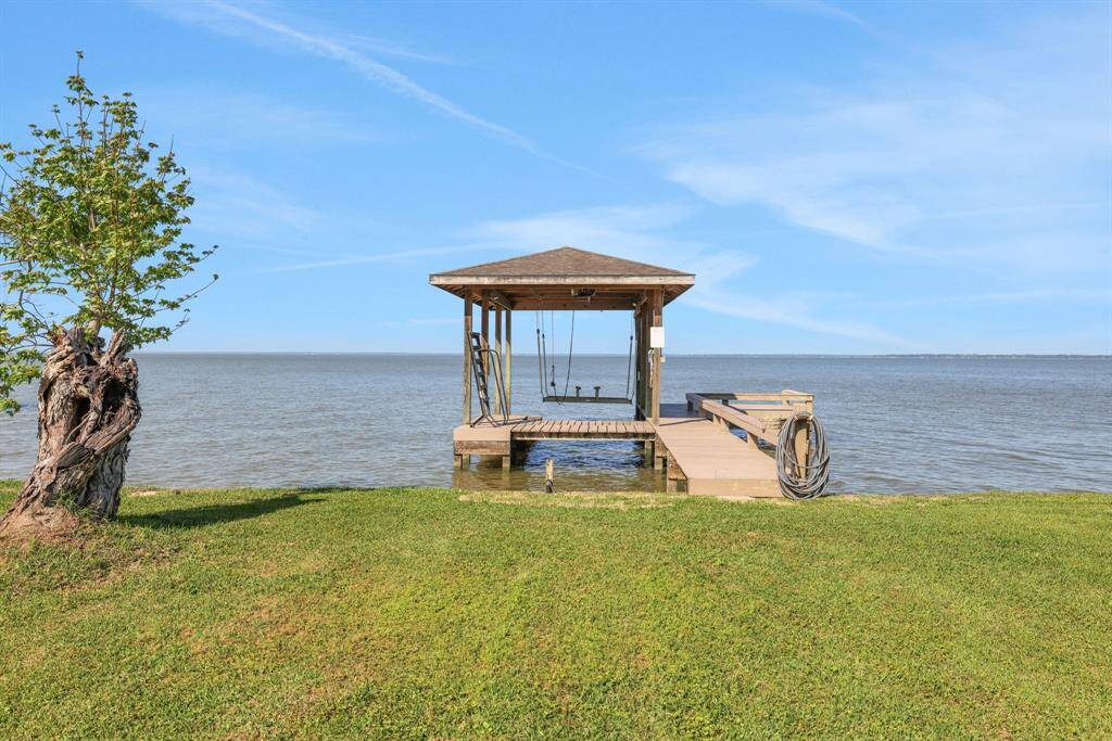 The boathouse has a seating area and boat lift