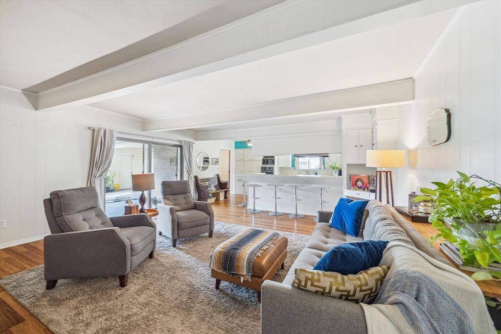 The spaces flow well into each other.  Built ins in the corner, full length breakfast bar plus a breakfast area to the right of the kitchen.  Sliders provide direct access to the fenced backyard.
