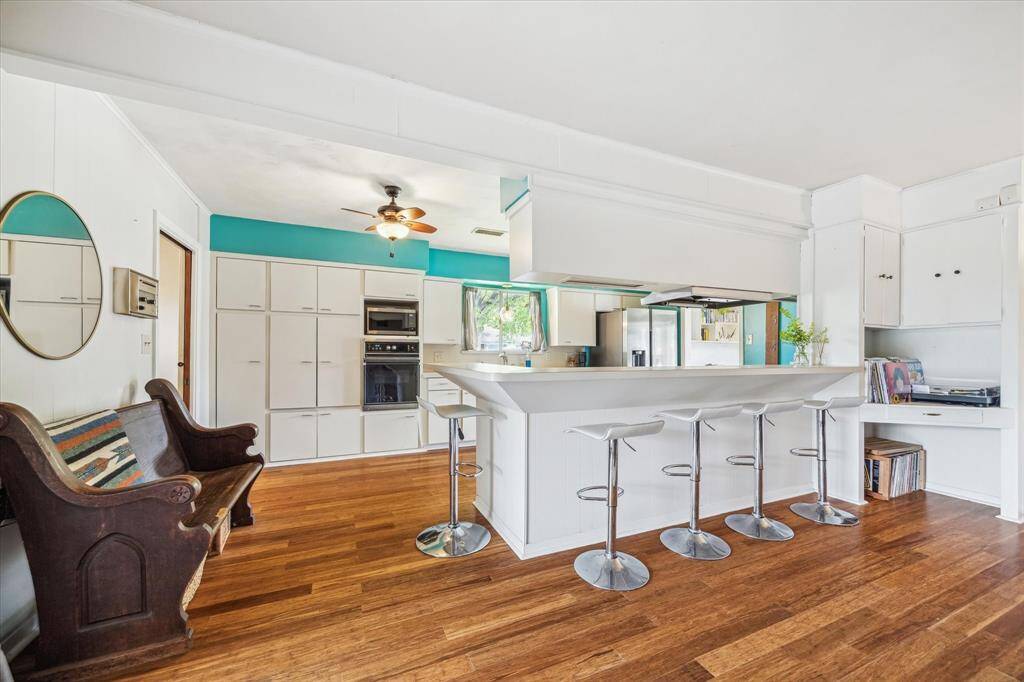 The kitchen/breakfast area is very open to the den & includes the slanted mid-century cabinetry detail.