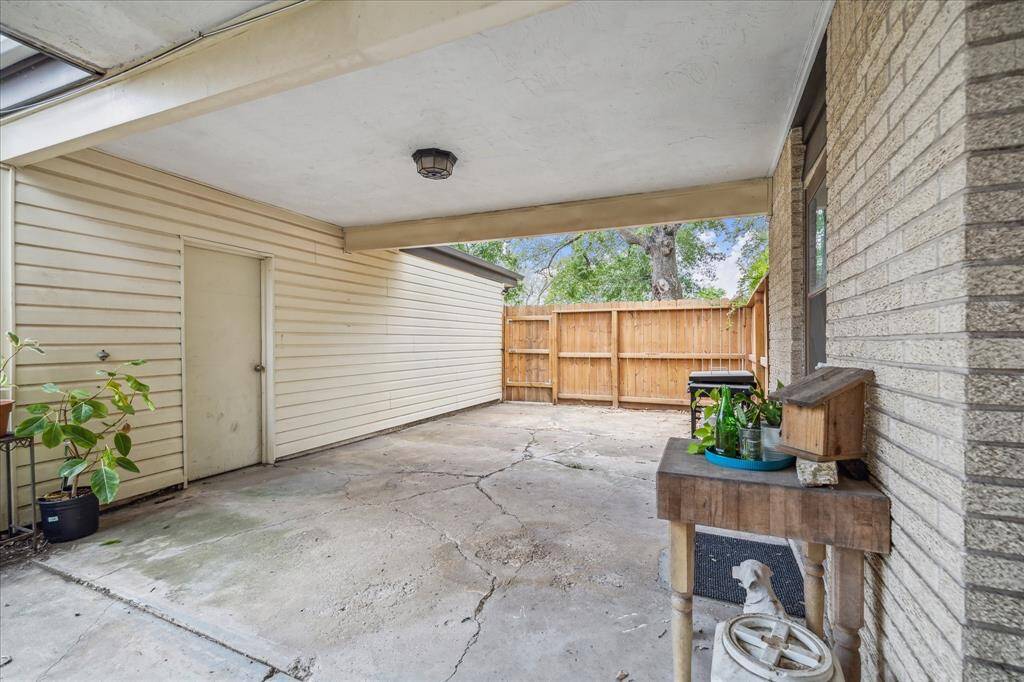 Additional patio area next to the garage with a privacy fence on the street side.